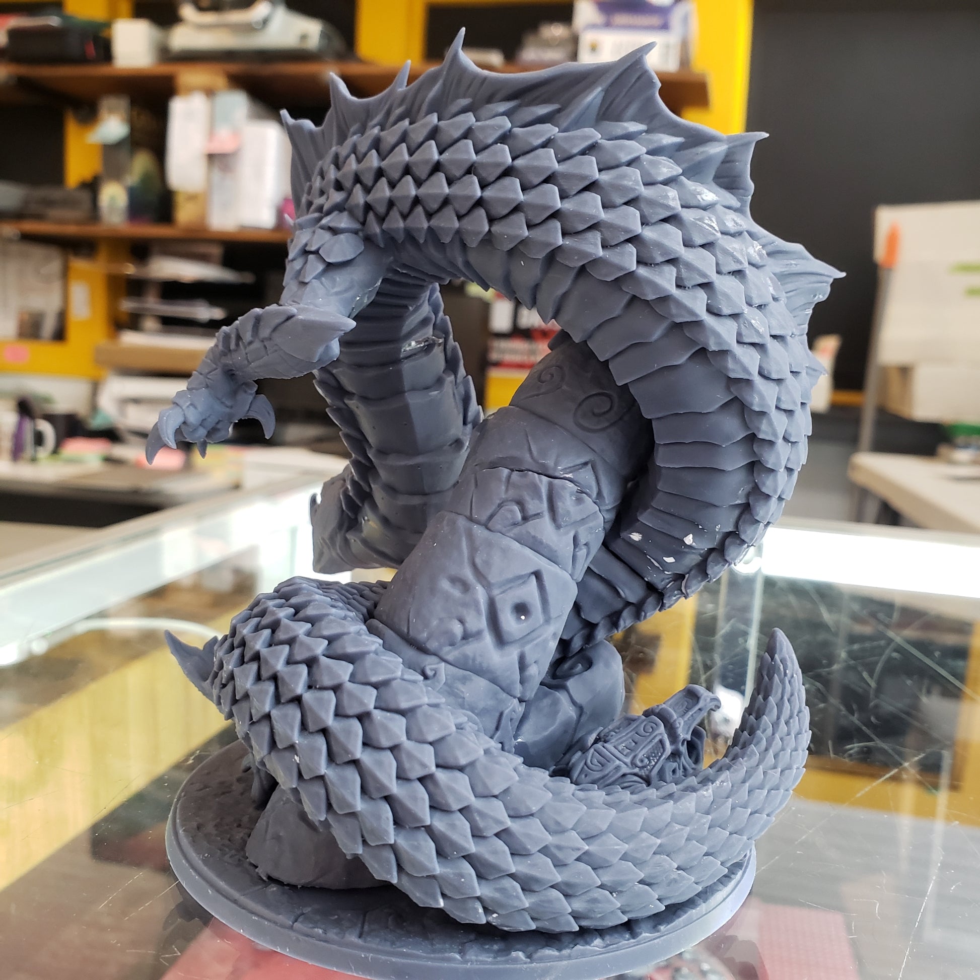 Image shows an example of a 3D printed snake-like dragon gaming miniature printed in-house at All Systems Go