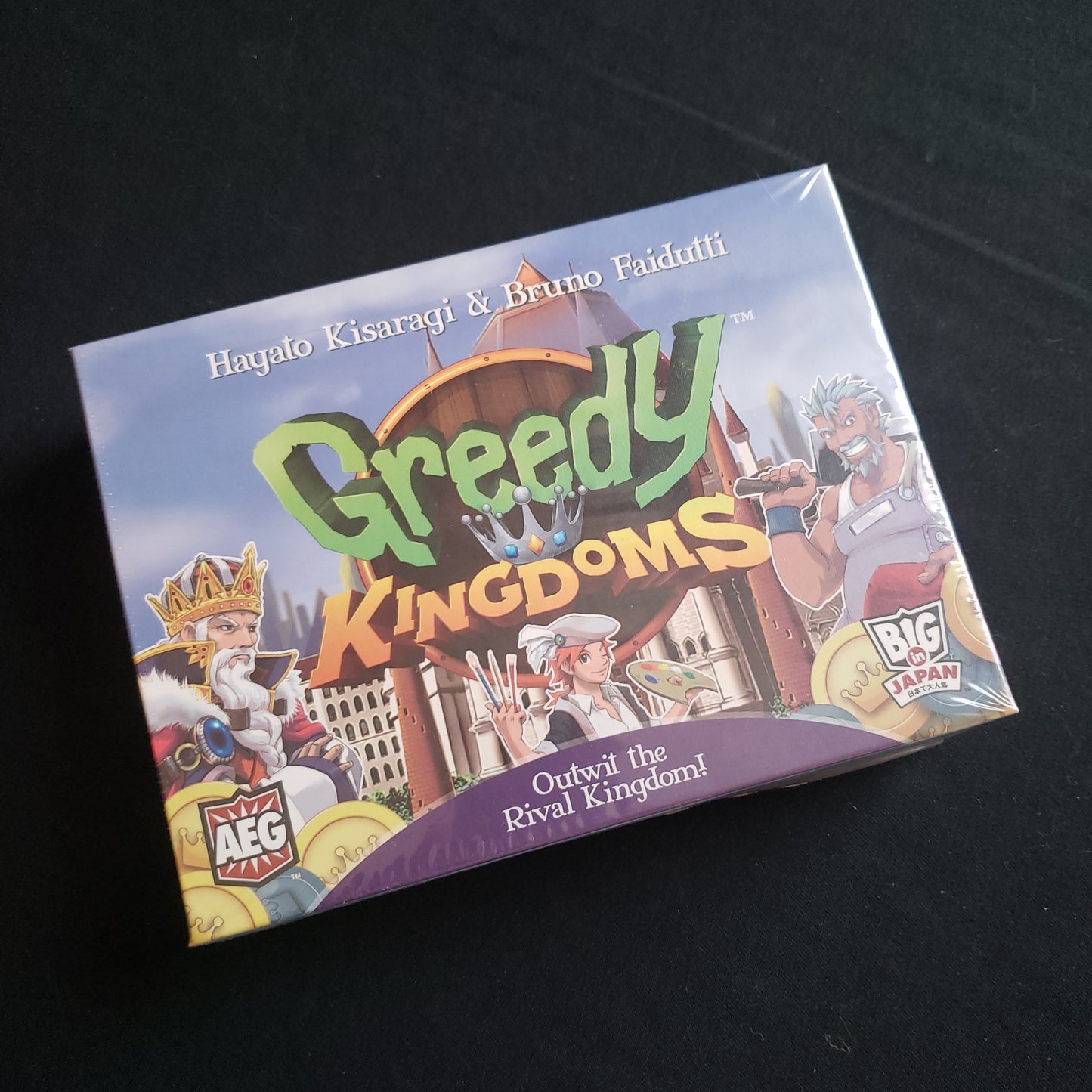 Image shows the front cover of the box of the Greedy Kingdoms board game