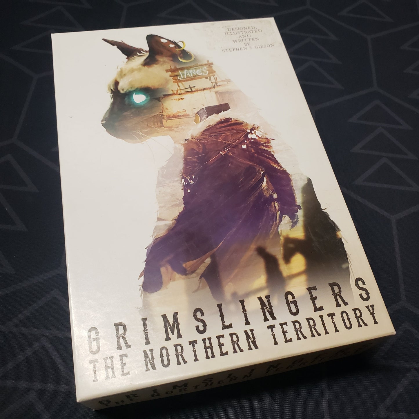 Image shows the front cover of the box of the Northern Territory expansion for the card game Grimslingers