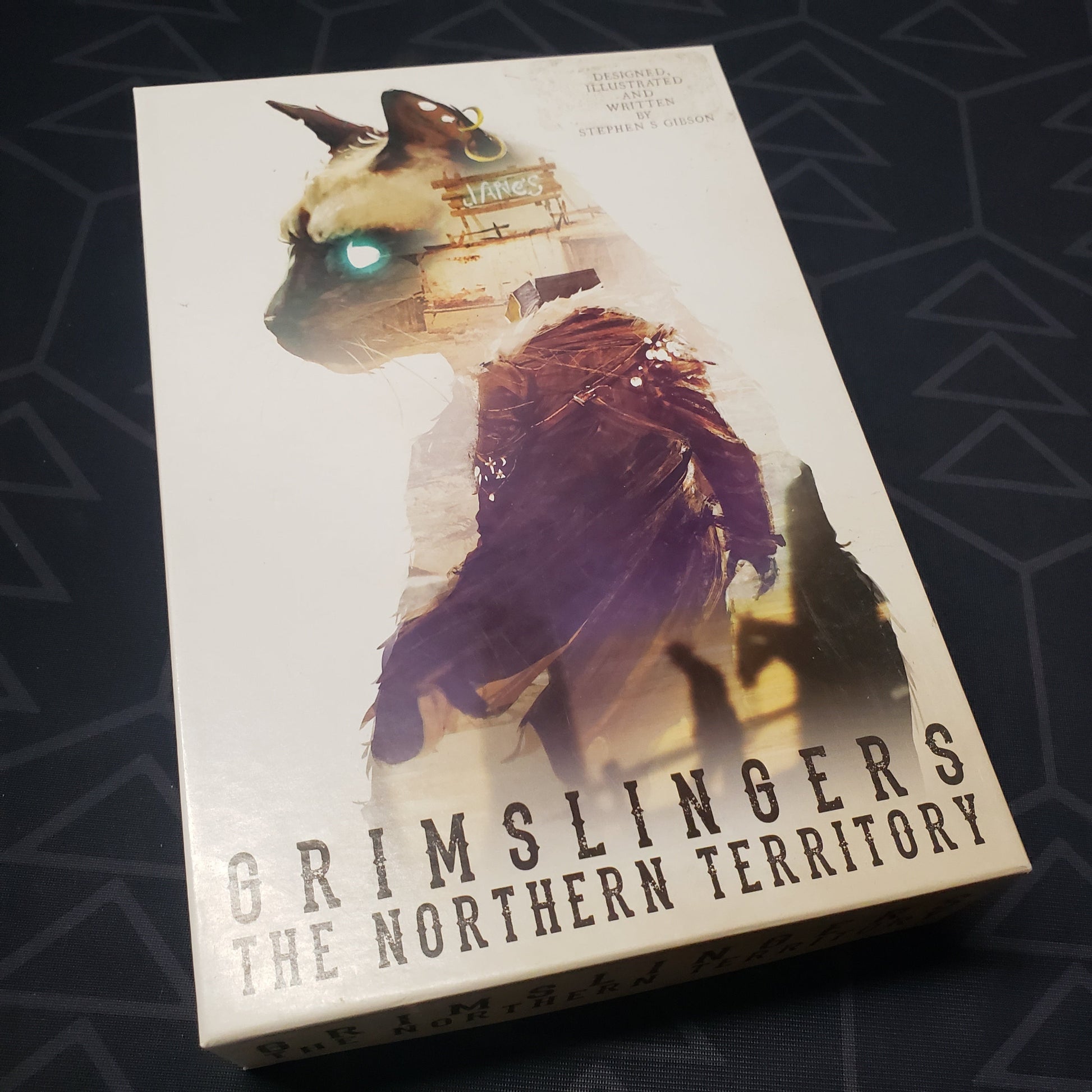 Image shows the front cover of the box of the Northern Territory expansion for the card game Grimslingers