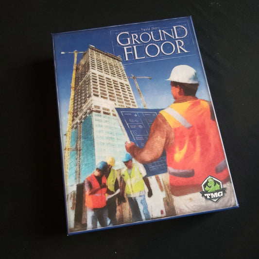 Image shows the front cover of the box of the Ground Floor board game