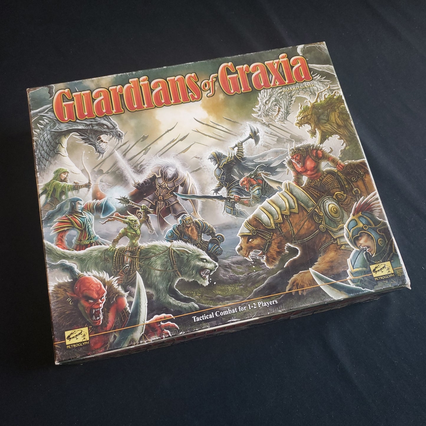 Image shows the front cover of the box of the Guardians of Graxia board game