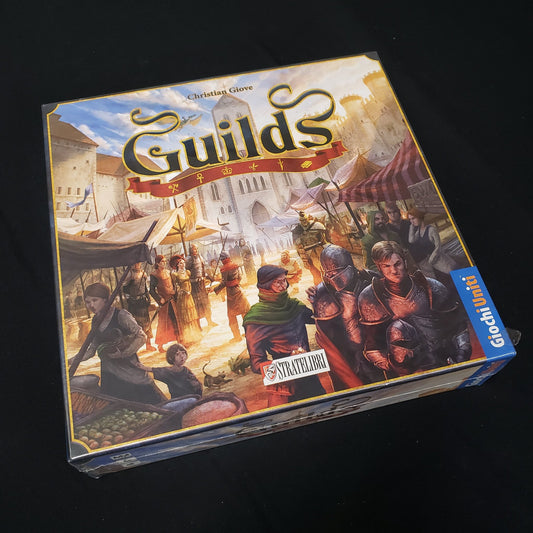 Image shows the front cover of the box of the Guilds board game