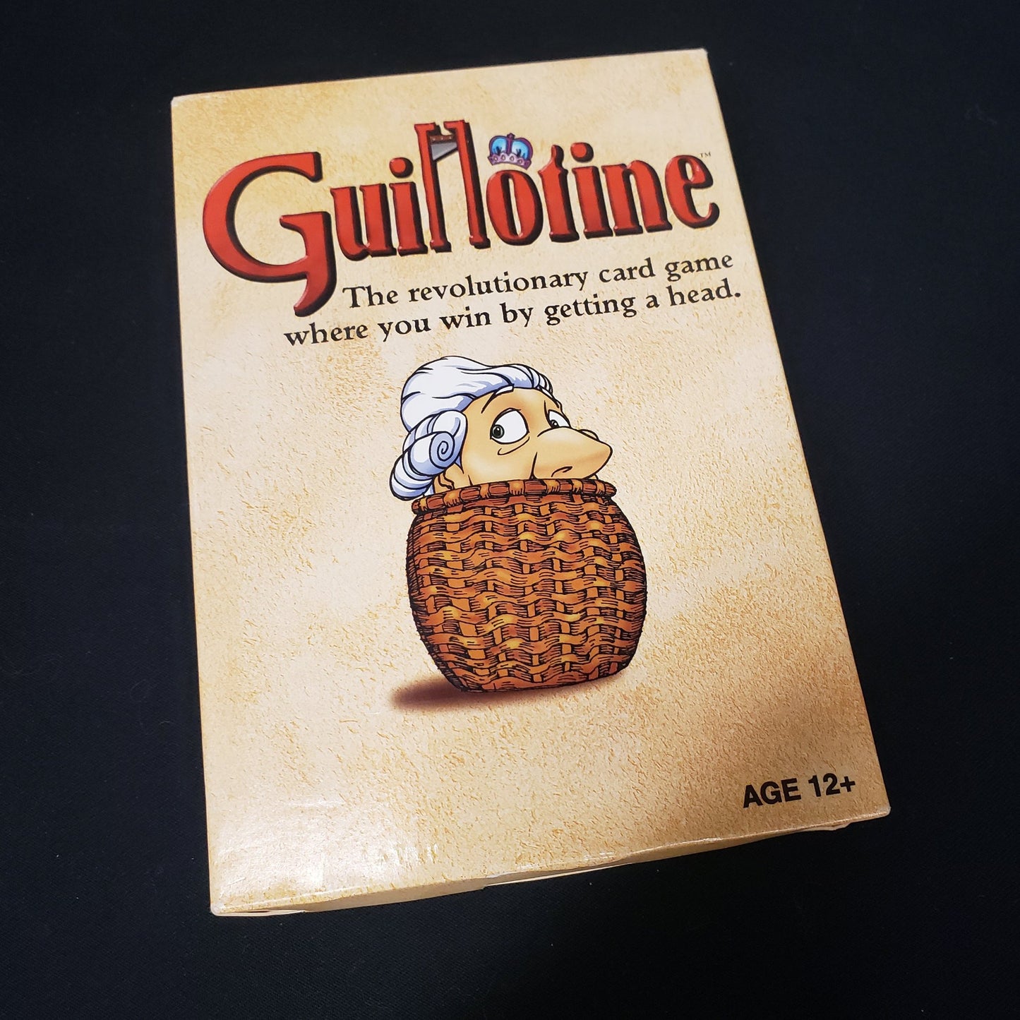 Image shows the front cover of the box of the Guillotine card game