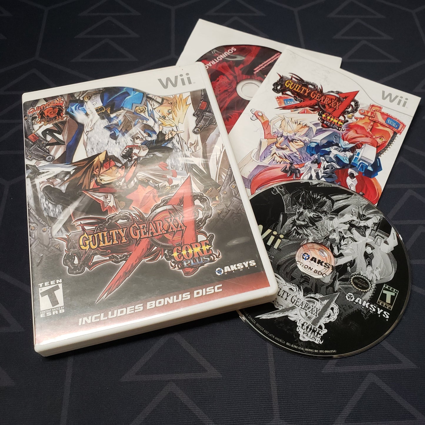 Image shows the case, manual, soundtrack CD and game disc for the video game Guilty Gear XX Accent Core Plus for Nintendo Wii