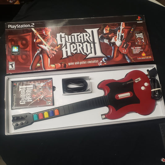Image shows the box and components of the SG Guitar Bundle for the video game Guitar Hero II for Playstation 2