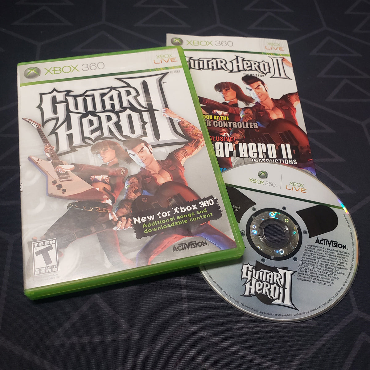 Image shows the case, manual and disc for the video game Guitar Hero II for Xbox 360