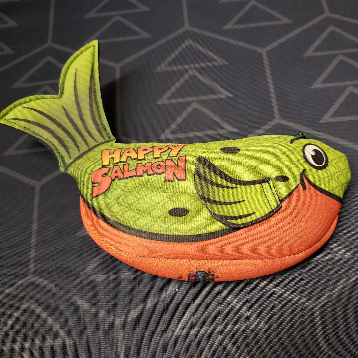 Image shows the front of the fish-shaped package of the Happy Salmon card game