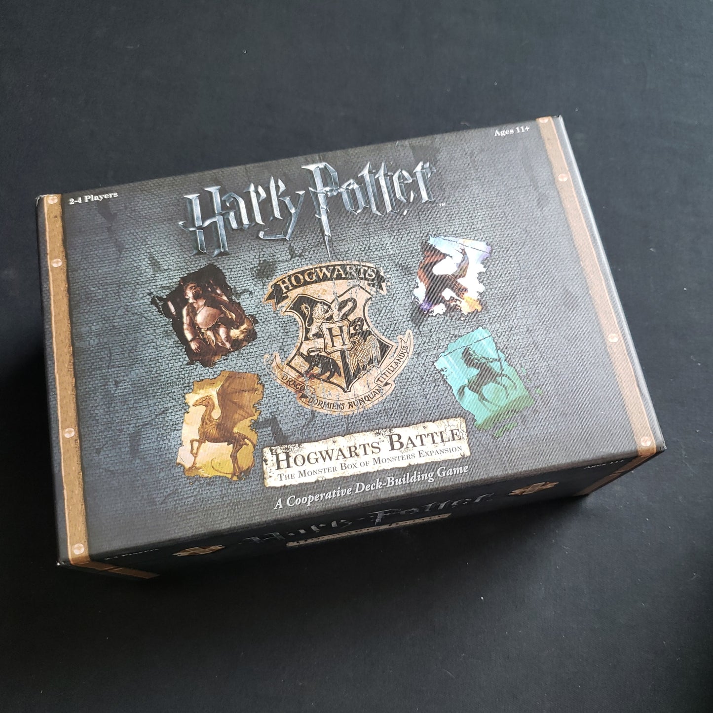 Image shows the front cover of the box of the Monster Box of Monsters expansion for the board game Harry Potter: Hogwarts Battle