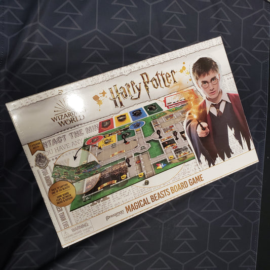 Image shows the front cover of the box for the Harry Potter: Magical Beasts board game