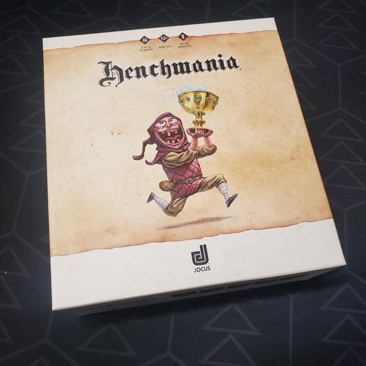 Image shows the front cover of the box for the Henchmania card game