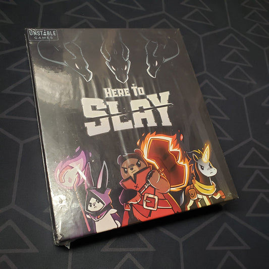 Image shows the front cover of the box for the Here to Slay (Retail Edition) card game
