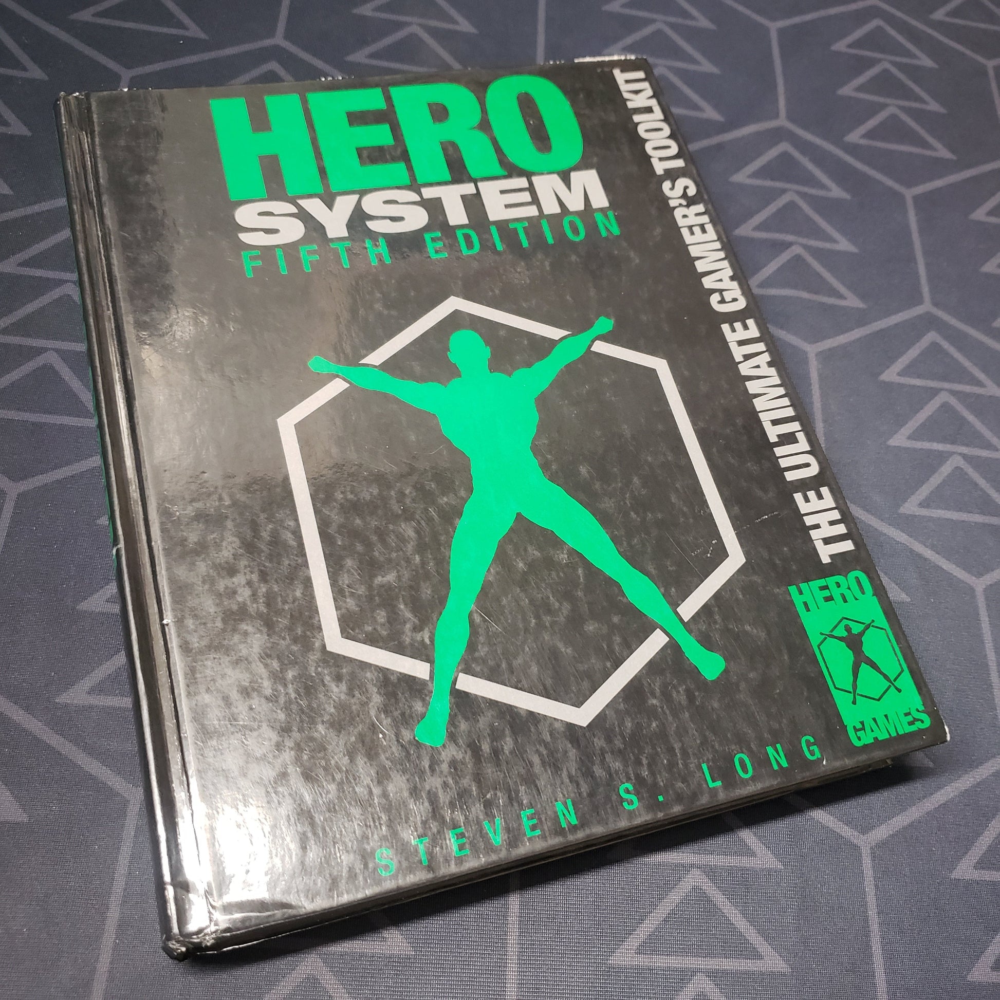 Image shows the front cover of the core rulebook for the roleplaying game Hero System: Fifth Edition