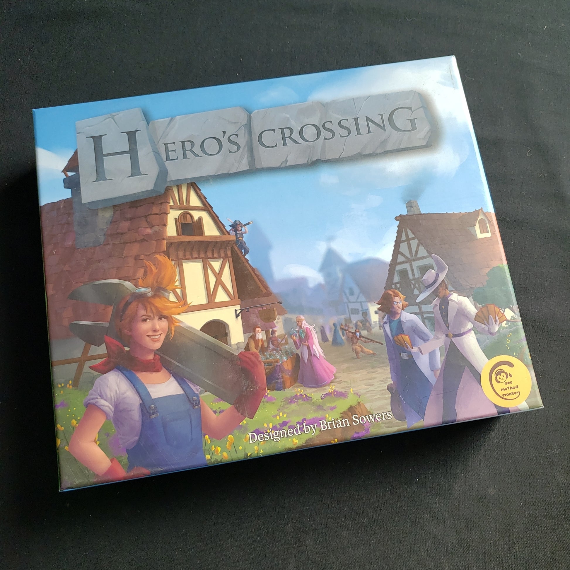 Image shows the front cover of the box of the Hero's Crossing board game