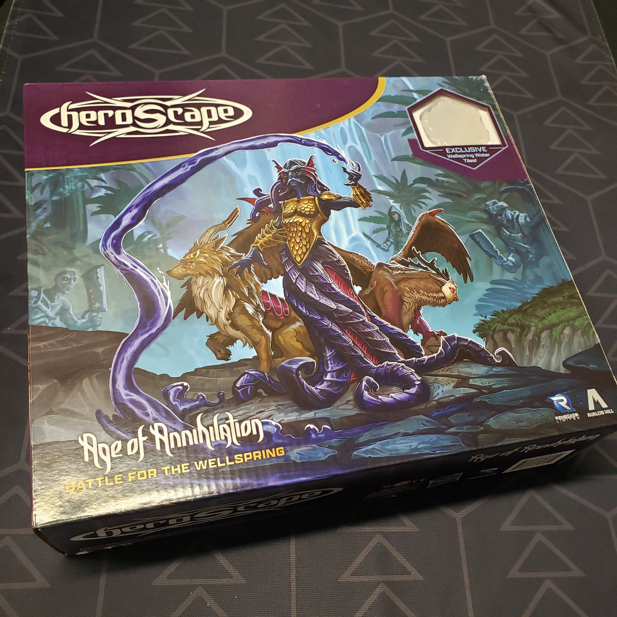 Image shows the front cover of the box for the Heroscape: Age of Annihilation - Battle for the Wellspring (Premium Painted Edition) board game