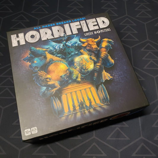 Image shows the front cover of the box for the Horrified: Greek Monsters board game