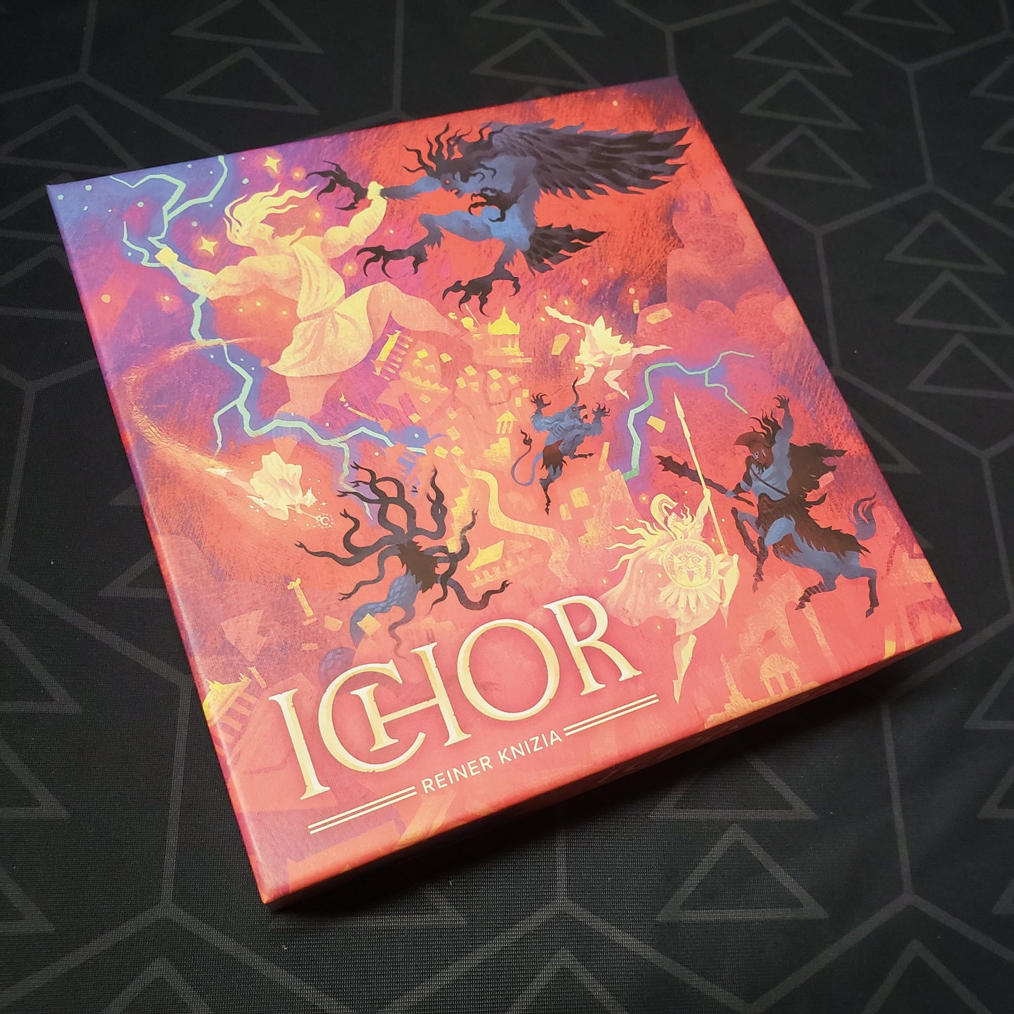 Image shows the front cover of the box for the Ichor board game