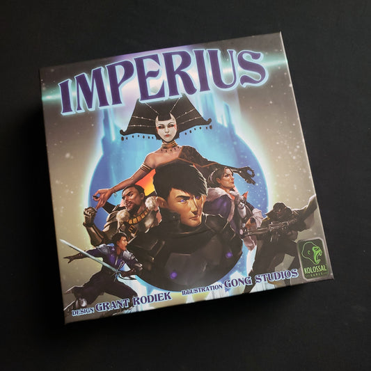 Image shows the front cover of the box of the Imperius card game