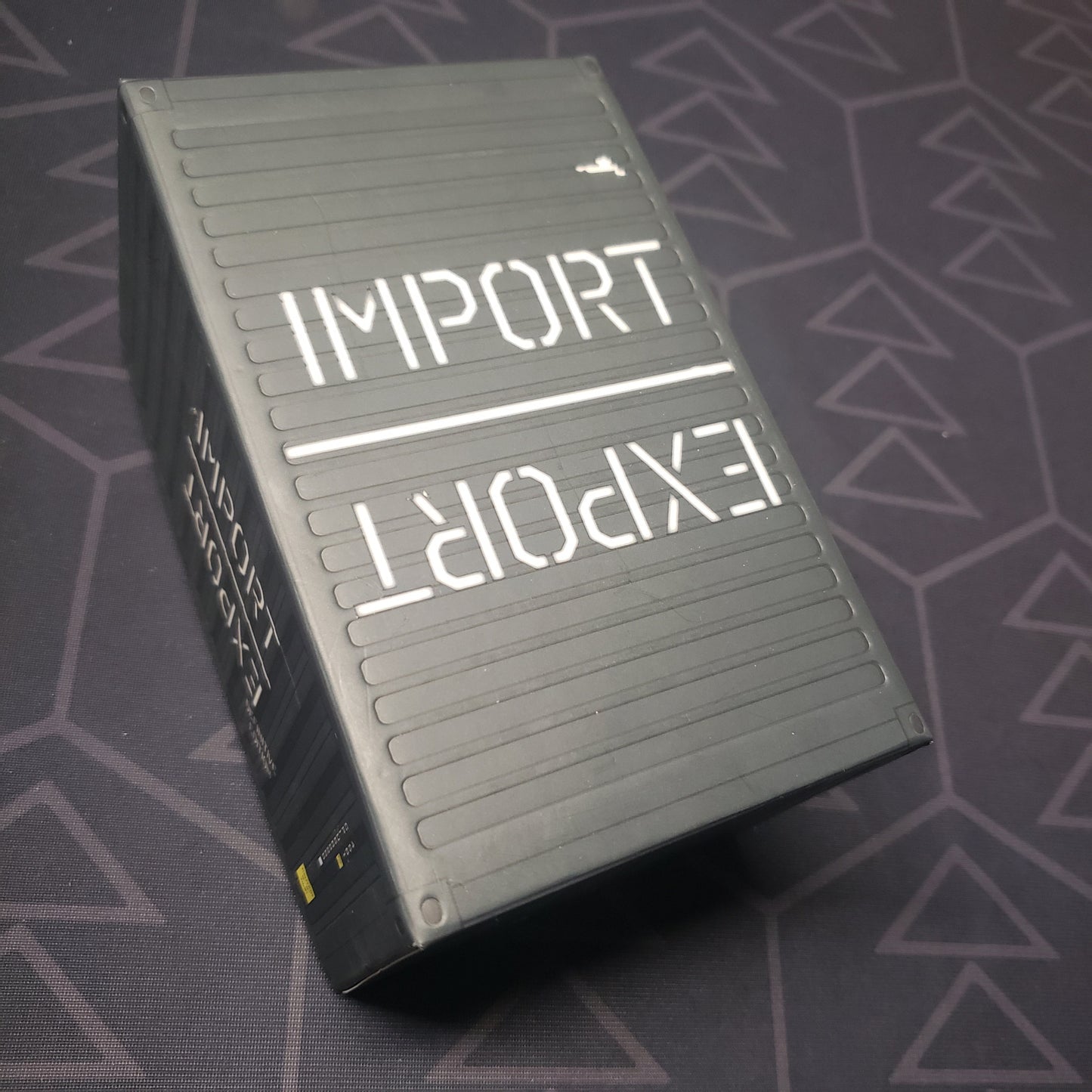 Image shows the front cover of the Definitive Edition box for the Import / Export card game