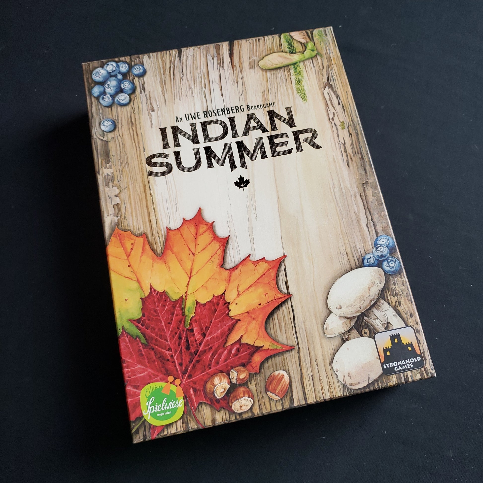 Image shows the front cover of the box of the Indian Summer board game