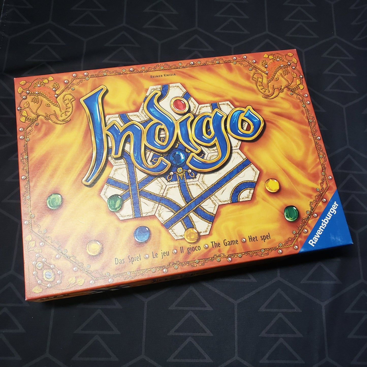 Image shows the front cover of the box for the Indigo board game