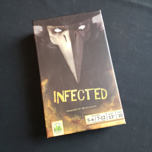 Image shows the front cover of the box of the Infected card game