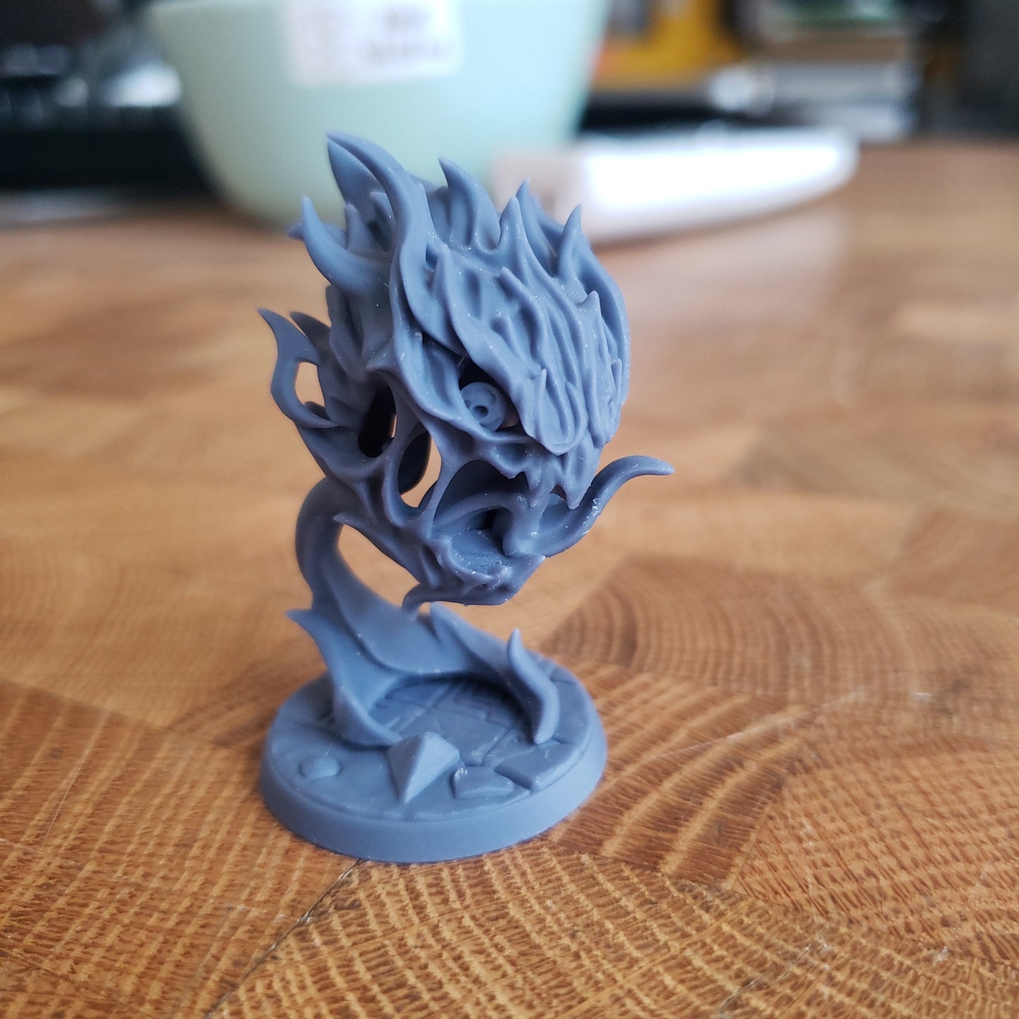 Image shows an example of a 3D printed fire elemental gaming miniature printed in-house at All Systems Go