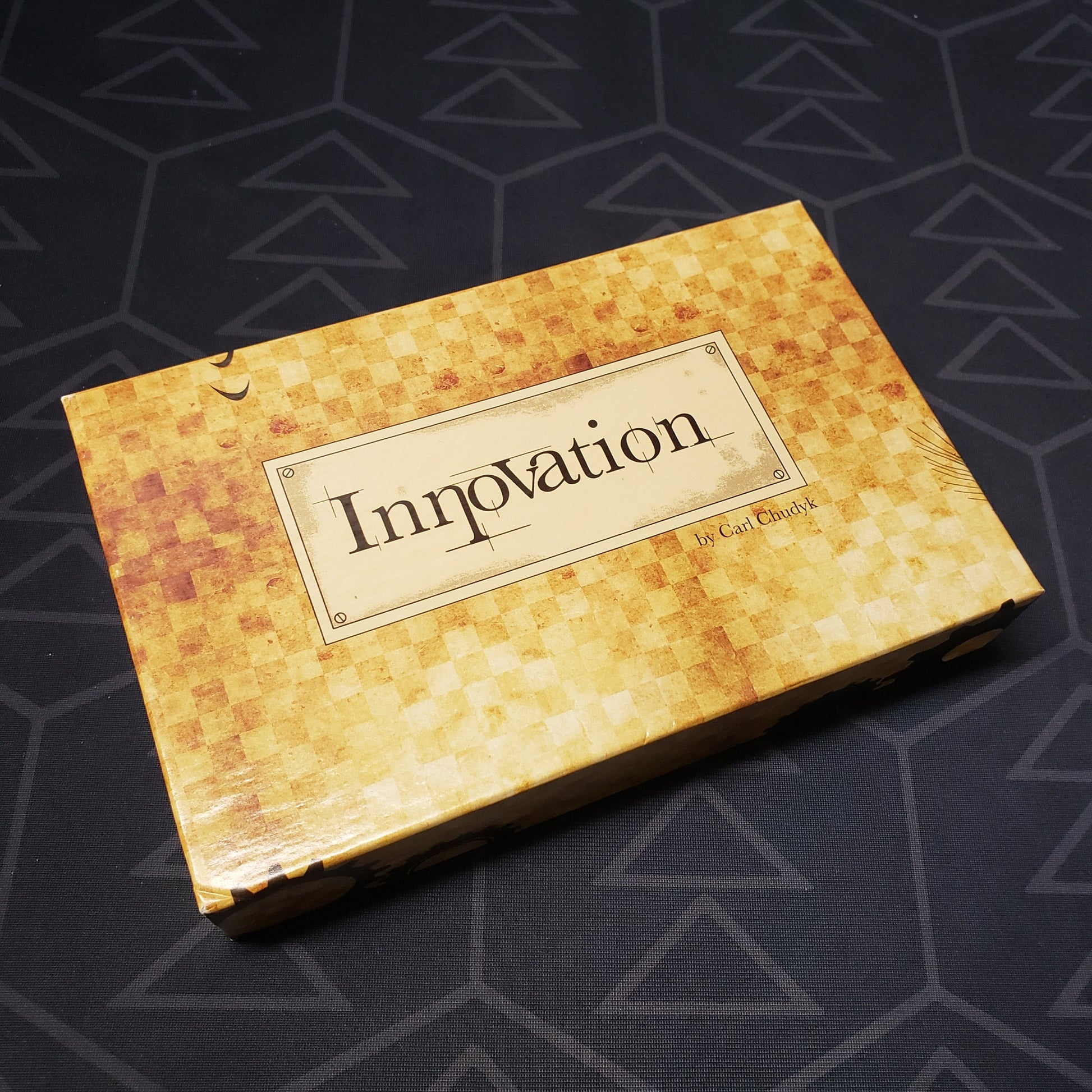 Image shows the front cover of the box for the Innovation (First Edition) card game