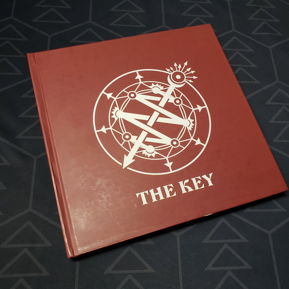 Image shows the front cover of the book The Key for the roleplaying game Invisible Sun