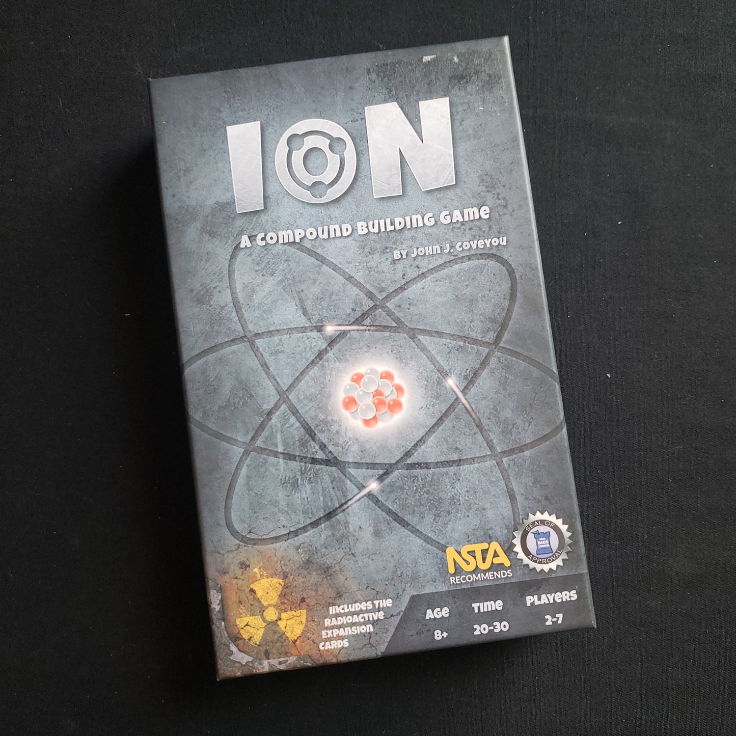 Image shows the front cover of the box of the Ion card game