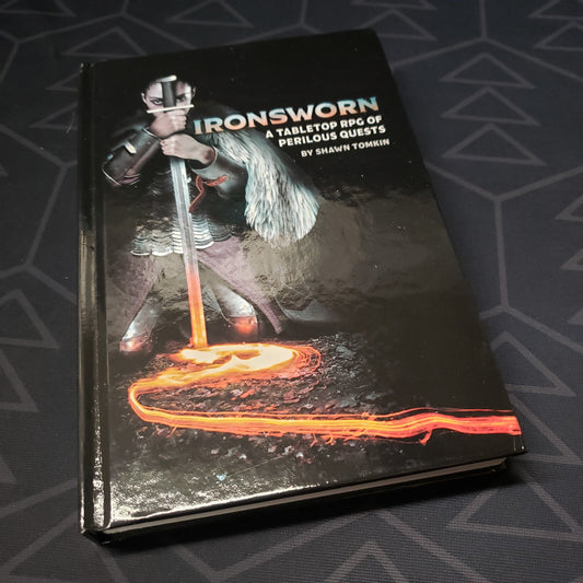 Image shows the front cover of the core rulebook for the roleplaying game Ironsworn