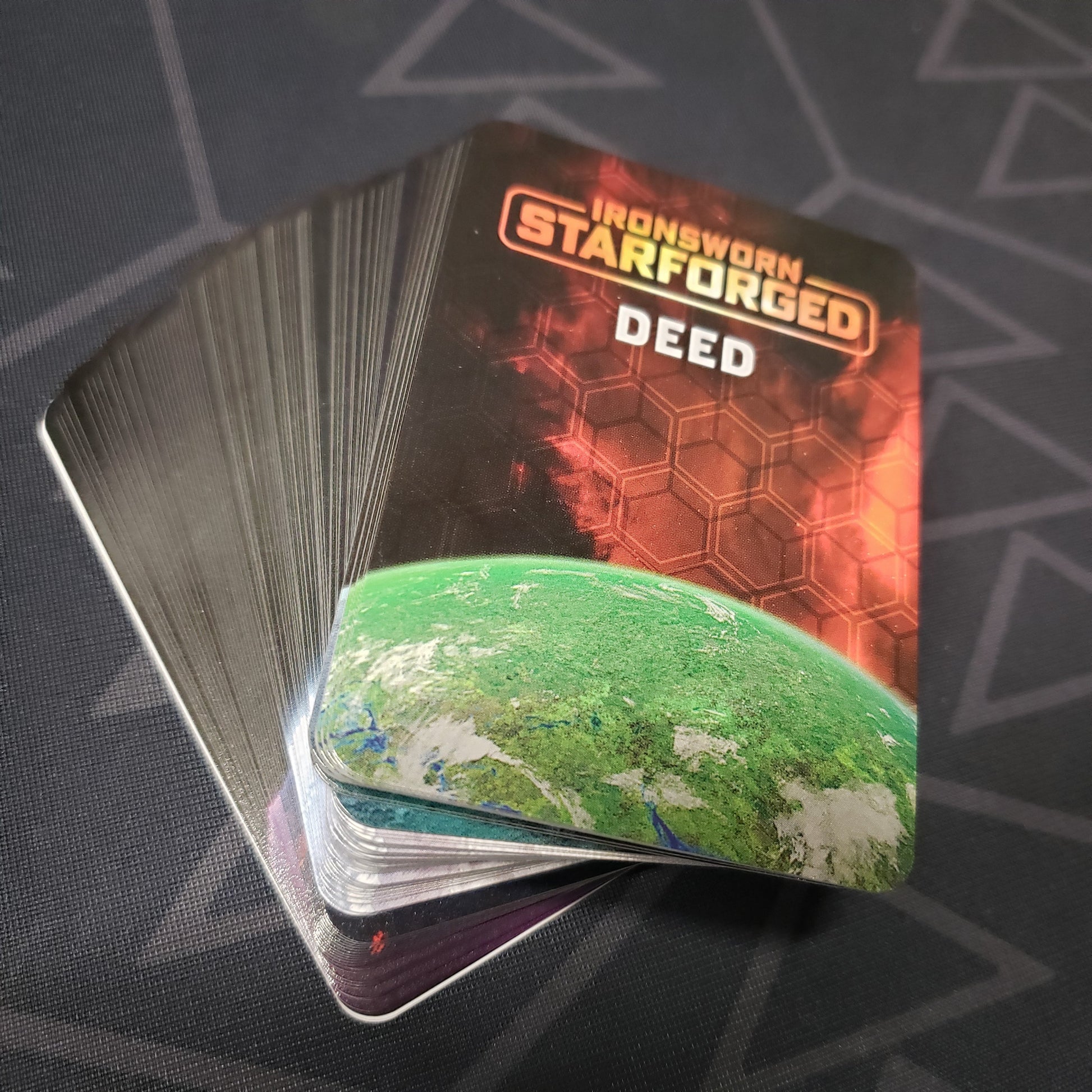 Image shows the fanned-out cards of the Asset Deck for the roleplaying game Ironsworn: Starforged