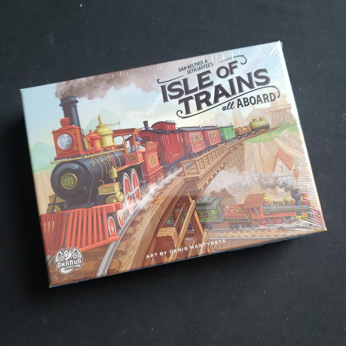 Image shows the front cover of the box of the Isle of Trains: All Aboard card game