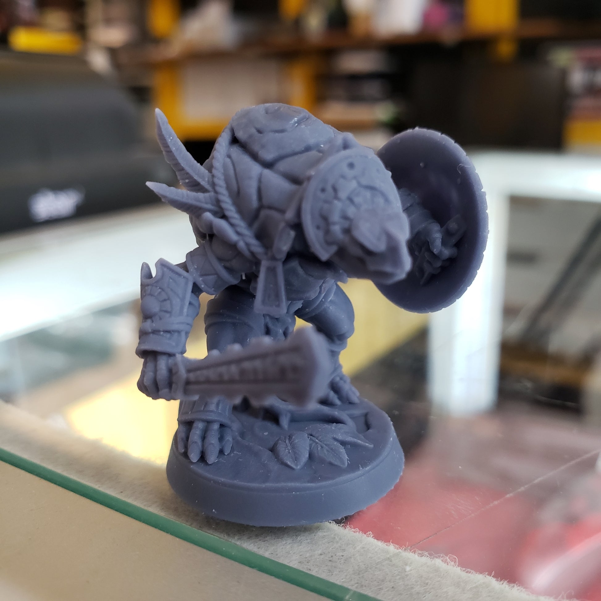 Image shows an example of a 3D printed turtle warrior gaming miniature printed in-house at All Systems Go