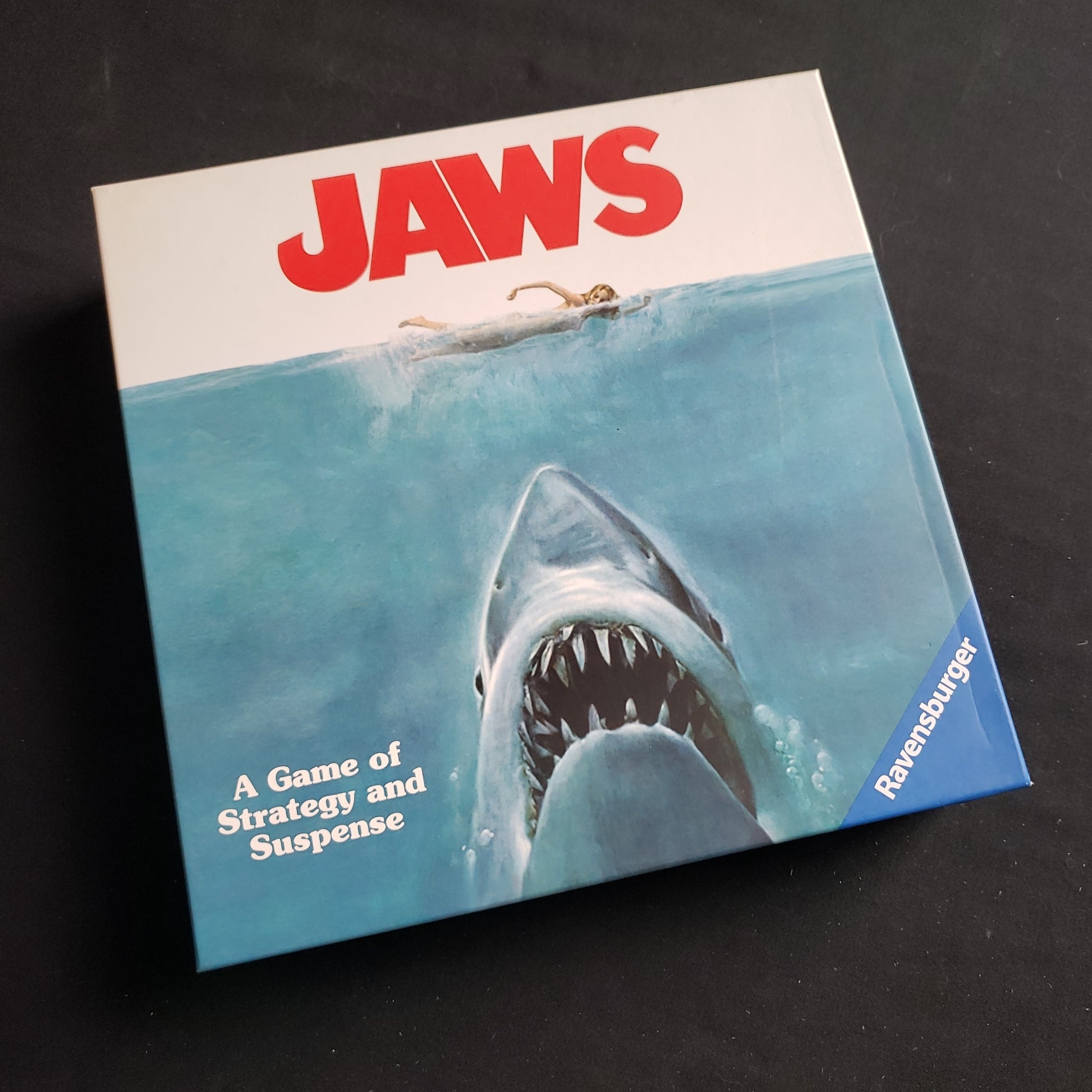 Image shows the front cover of the box of the Jaws board game