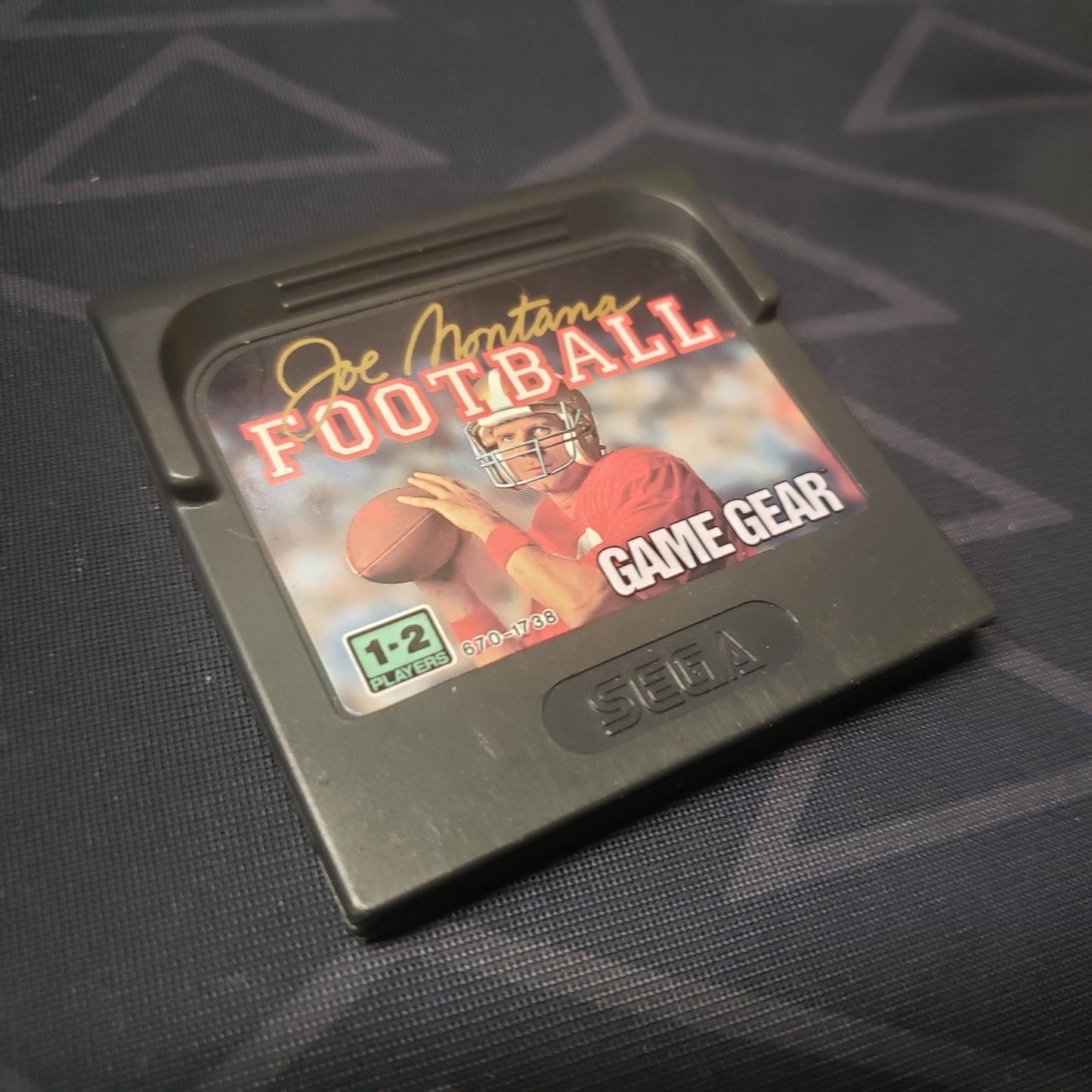 Image shows the front of the cartridge for the video game Joe Montana Football for the Sega Game Gear