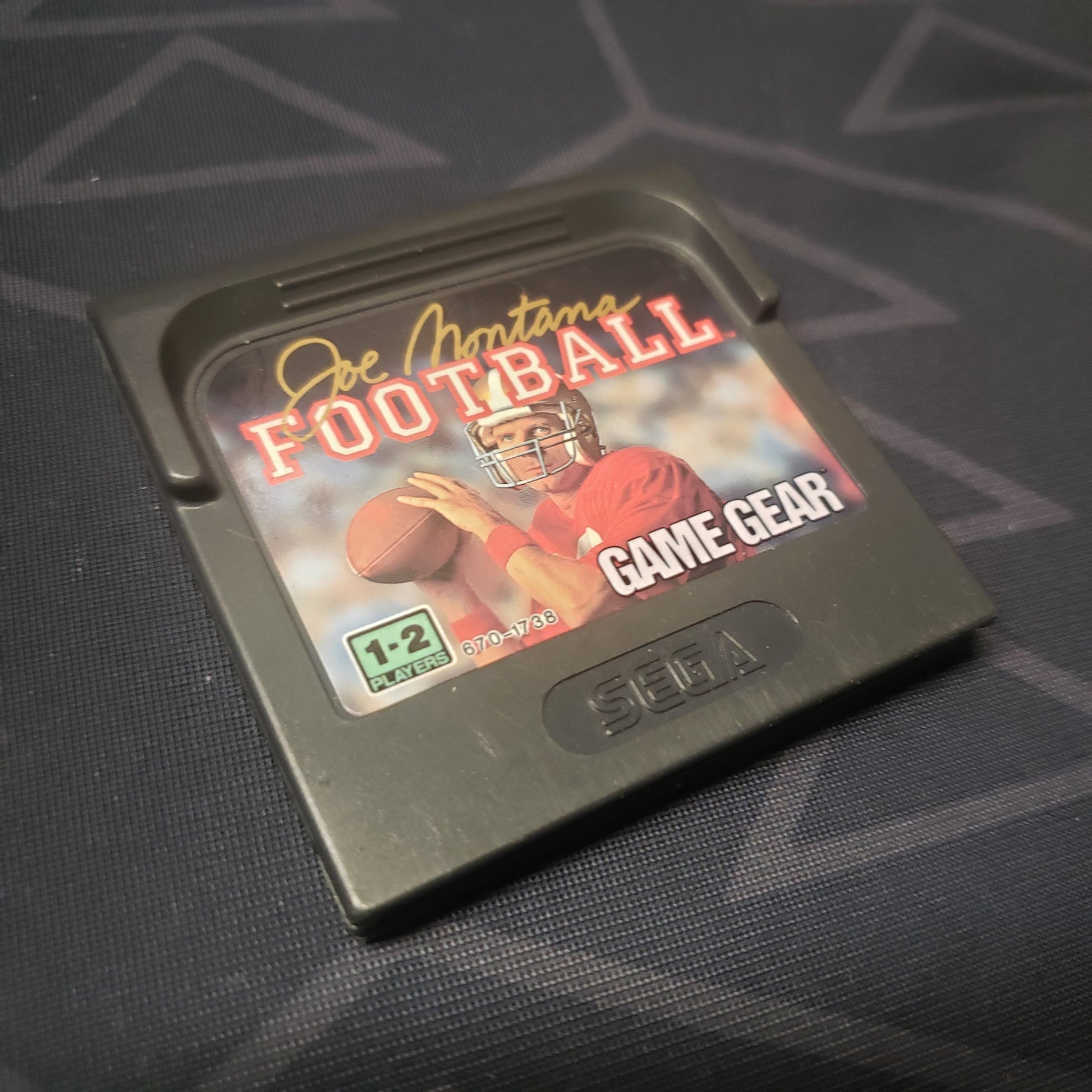 Image shows the front of the cartridge for the video game Joe Montana Football for the Sega Game Gear