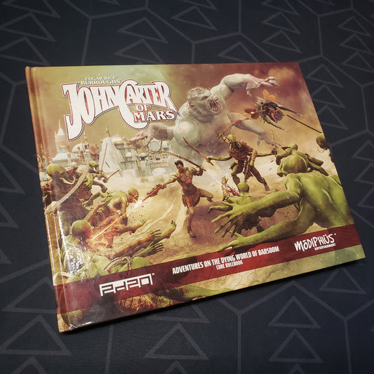 Image shows the front cover of the core rulebook for the roleplaying game John Carter of Mars: Adventures on the Dying World of Barsoom