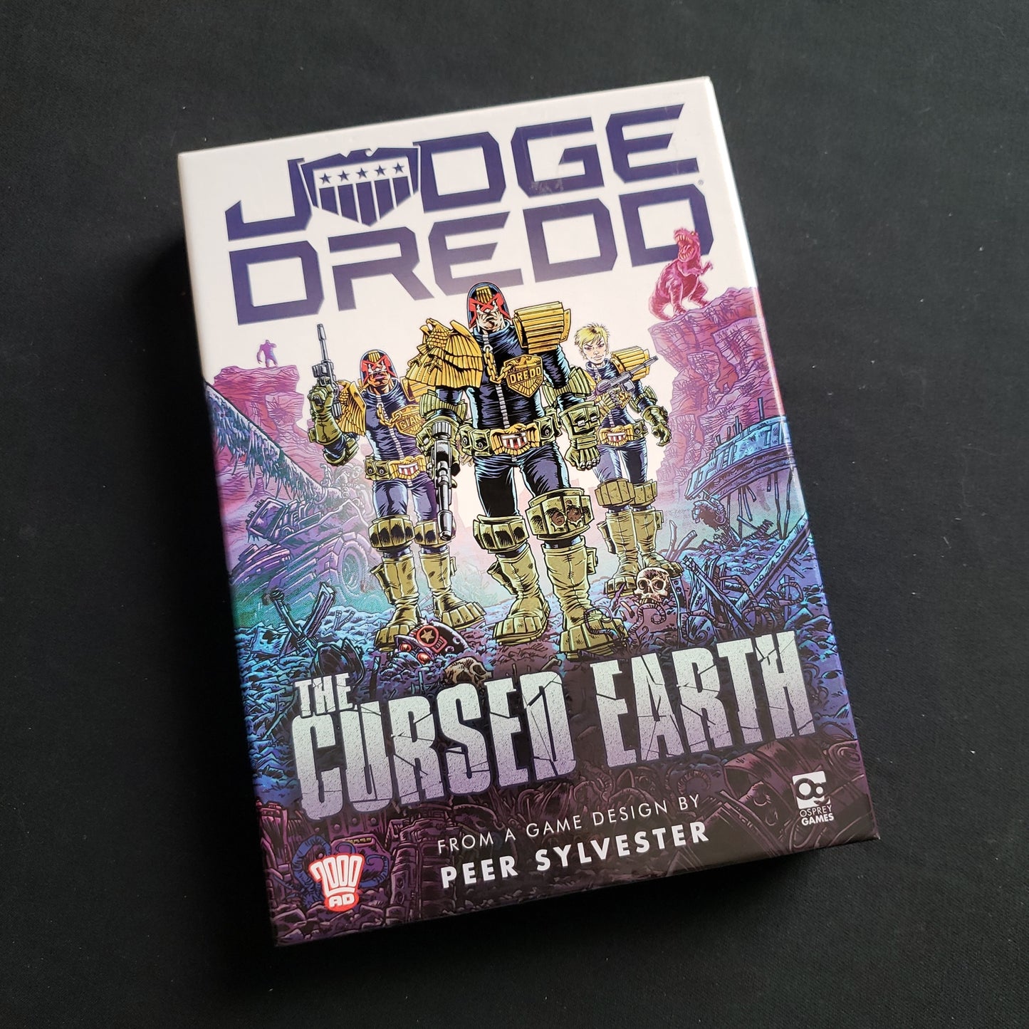 Image shows the front cover of the box of the Judge Dredd: The Cursed Earth card game