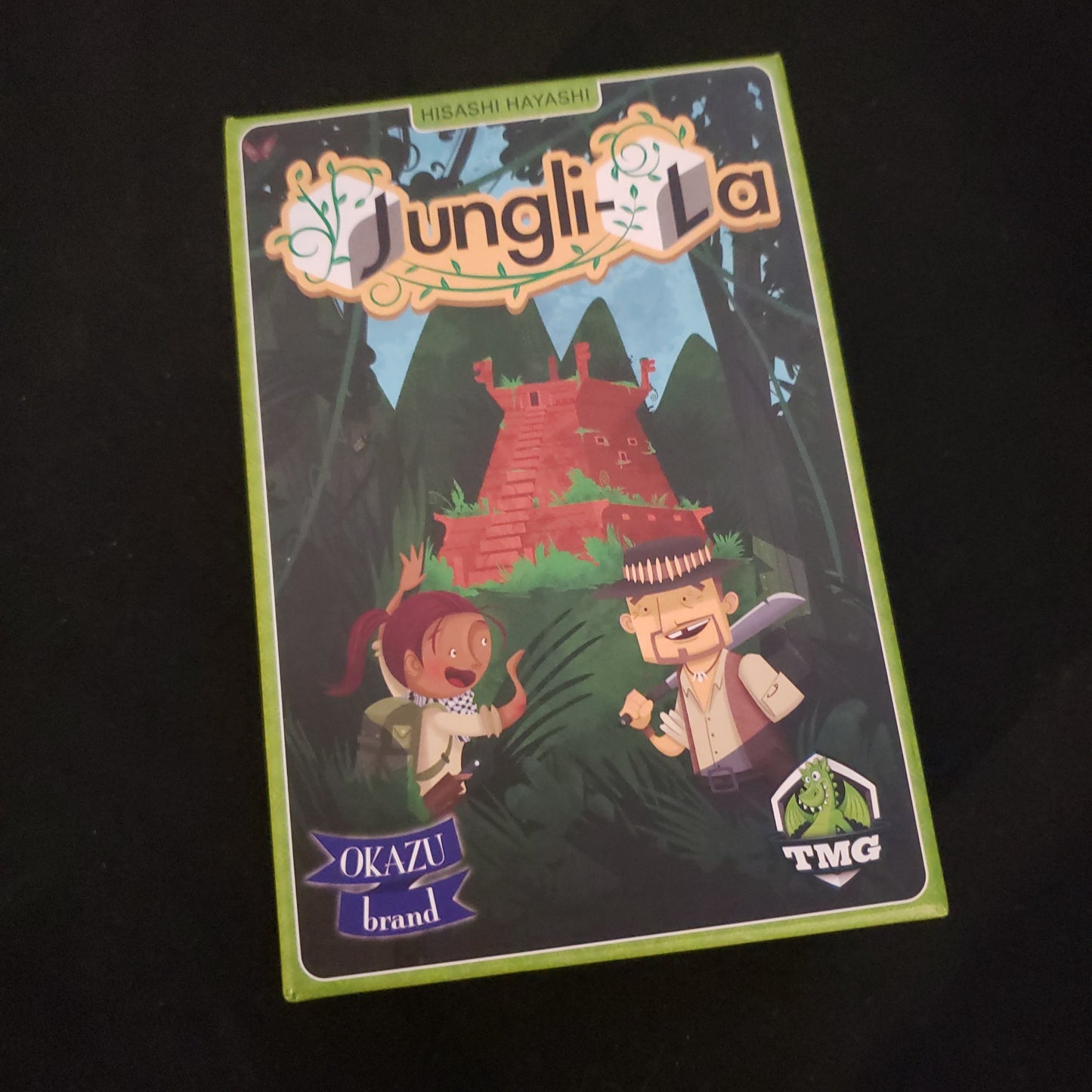 Image shows the front cover of the box of the Jungli-La board game