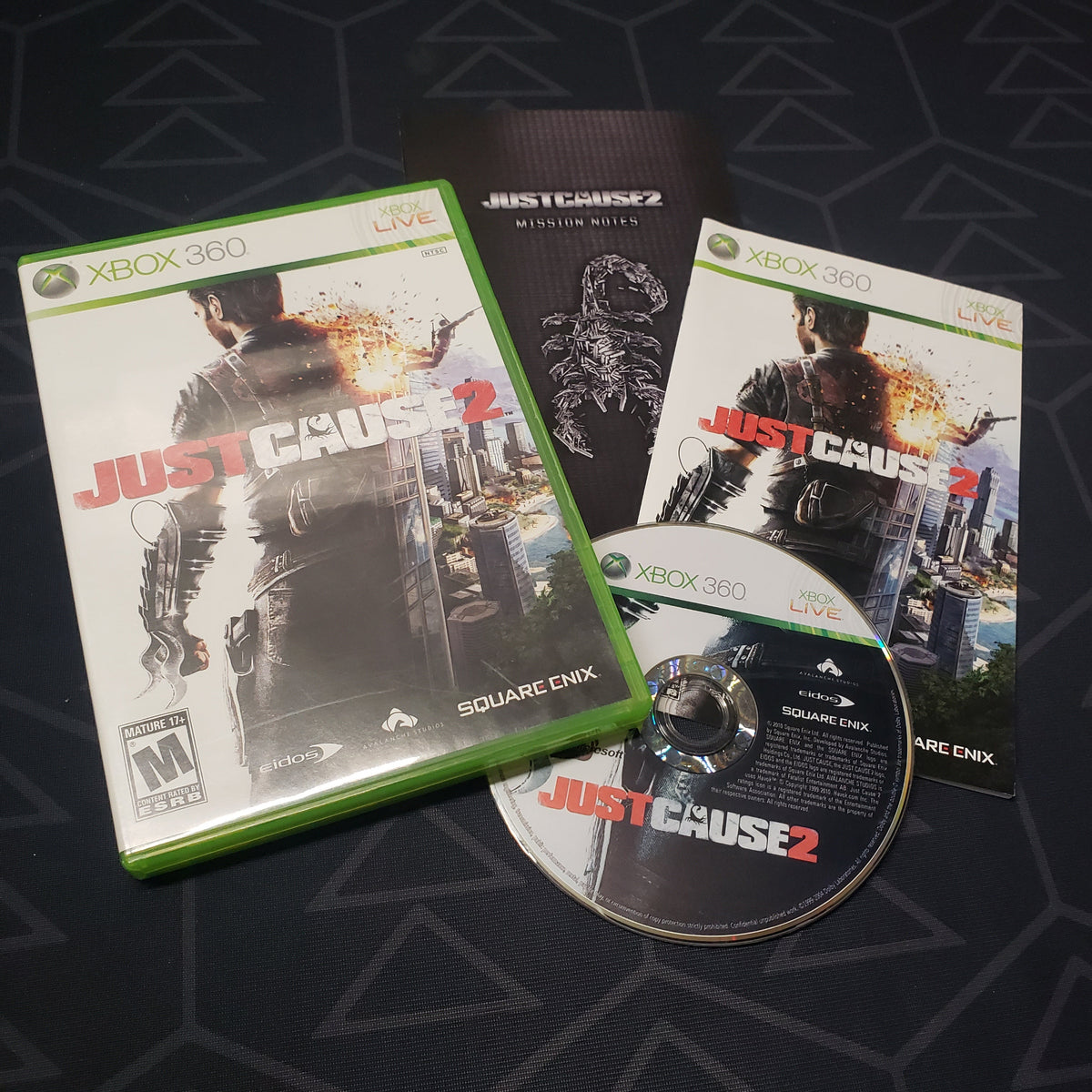 Image shows the case, manual and disc for the video game Just Cause 2 for Xbox 360