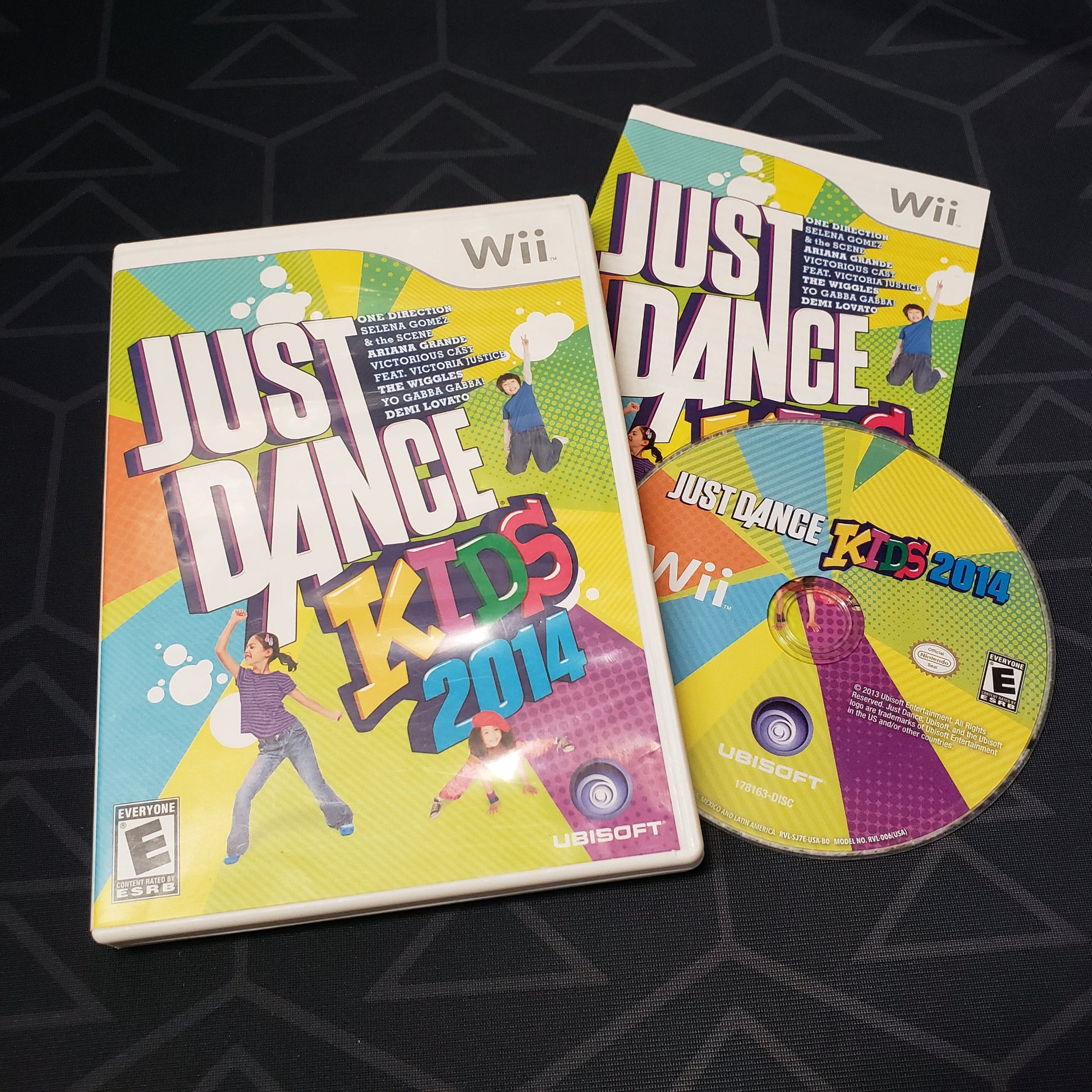 Image shows the case, manual and disc for the video game Just Dance Kids 2014 for Nintendo Wii