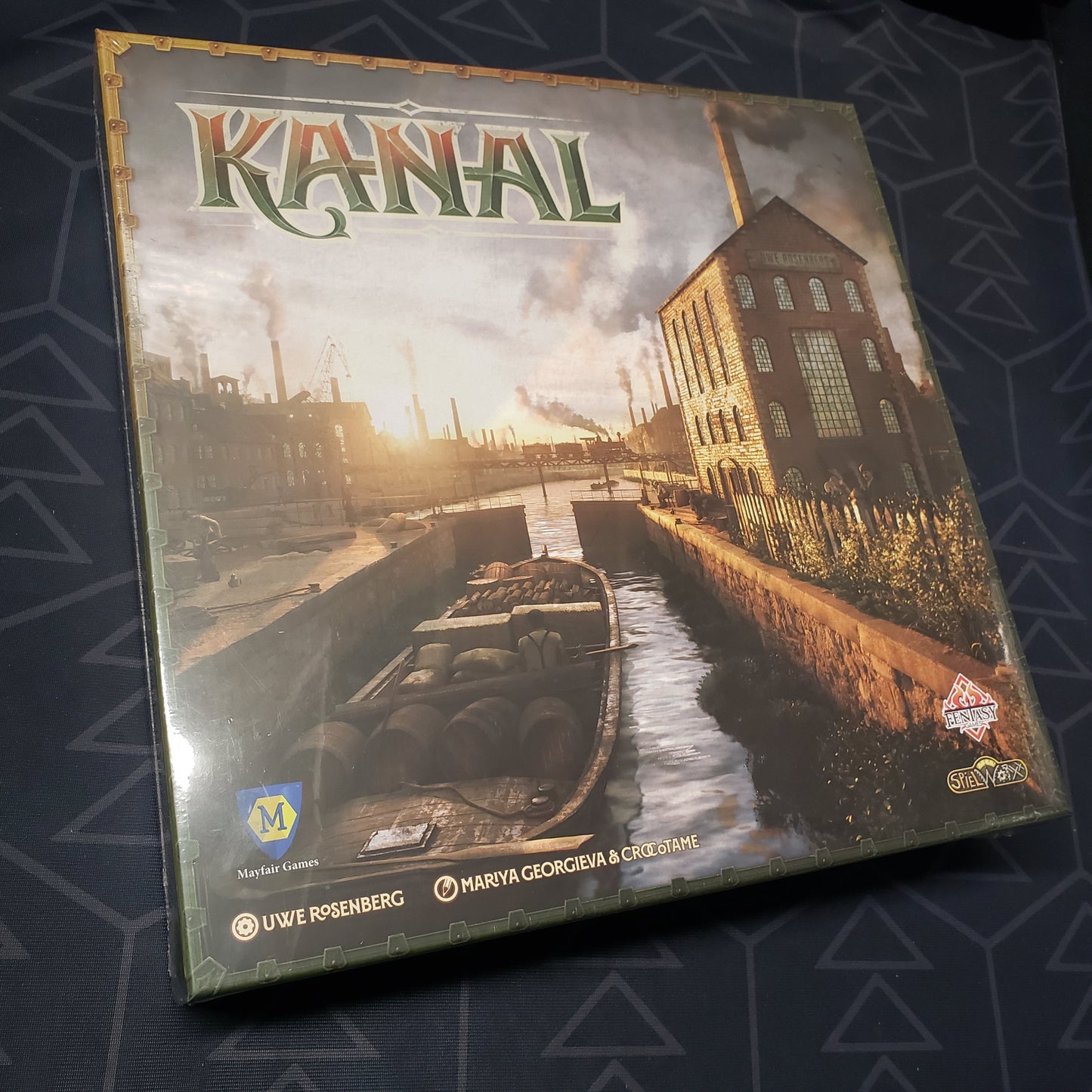 Image shows the front cover of the box for the Kanal board game