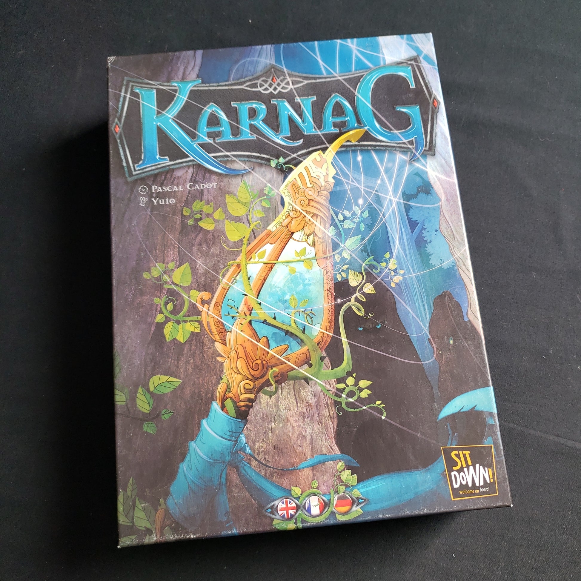 Image shows the front cover of the box of the Karnag board game