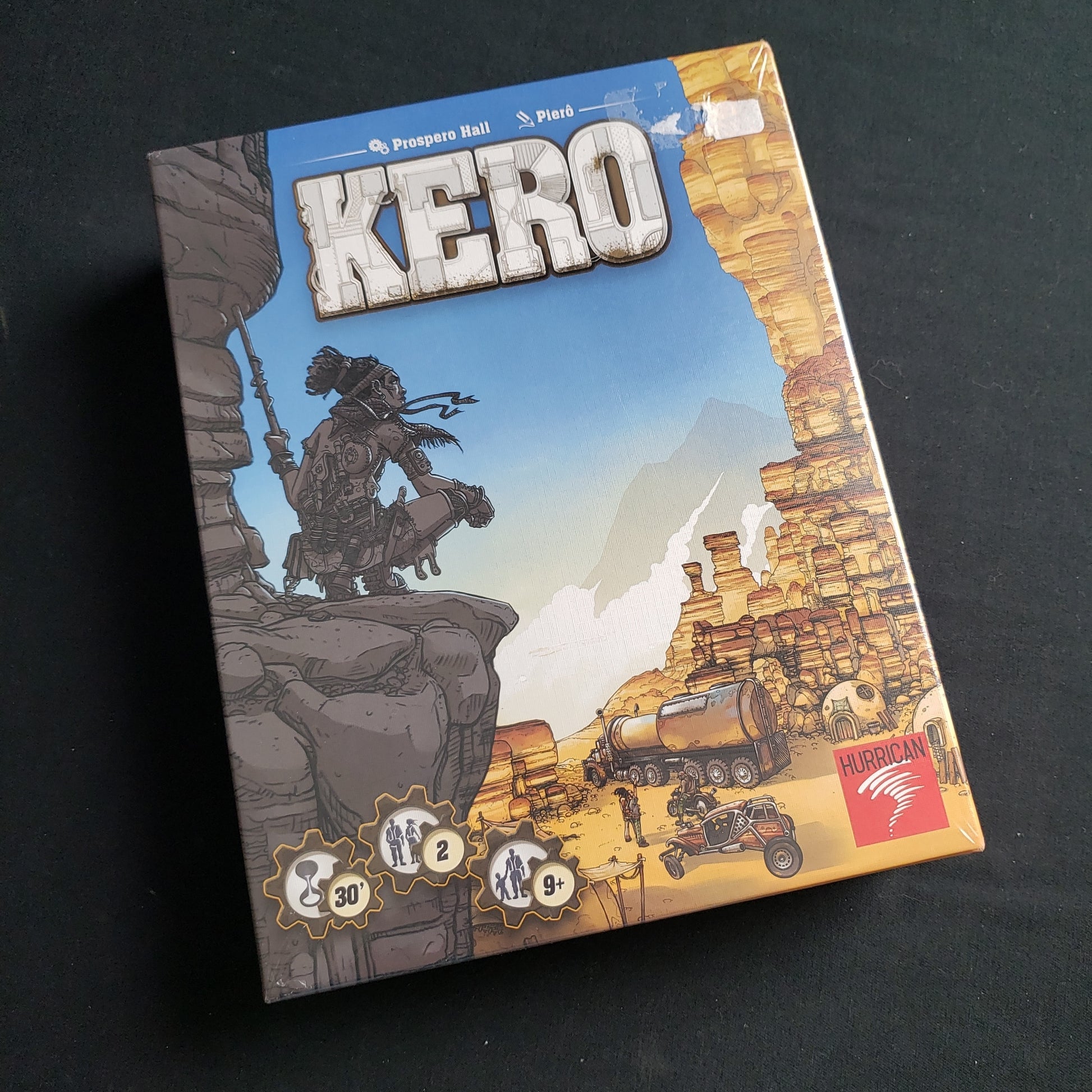 Image shows the front cover of the box of the Kero board game