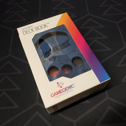Image shows the front of the package for the blue Keyforge Deck Book deck box