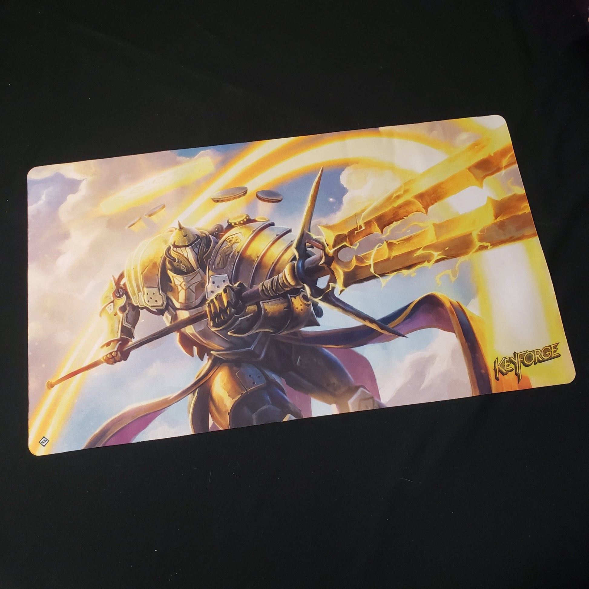 Image shows a playmat featuring the Raiding Knight artwork for the card game Keyforge