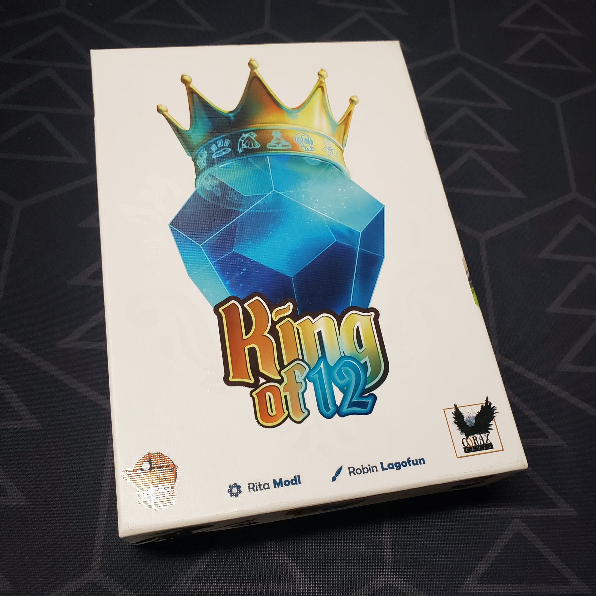 Image shows the front cover of the box for the King of 12 card game