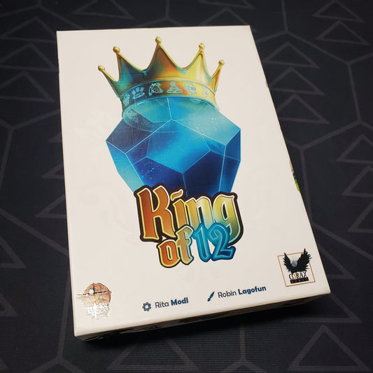 Image shows the front cover of the box for the King of 12 card game