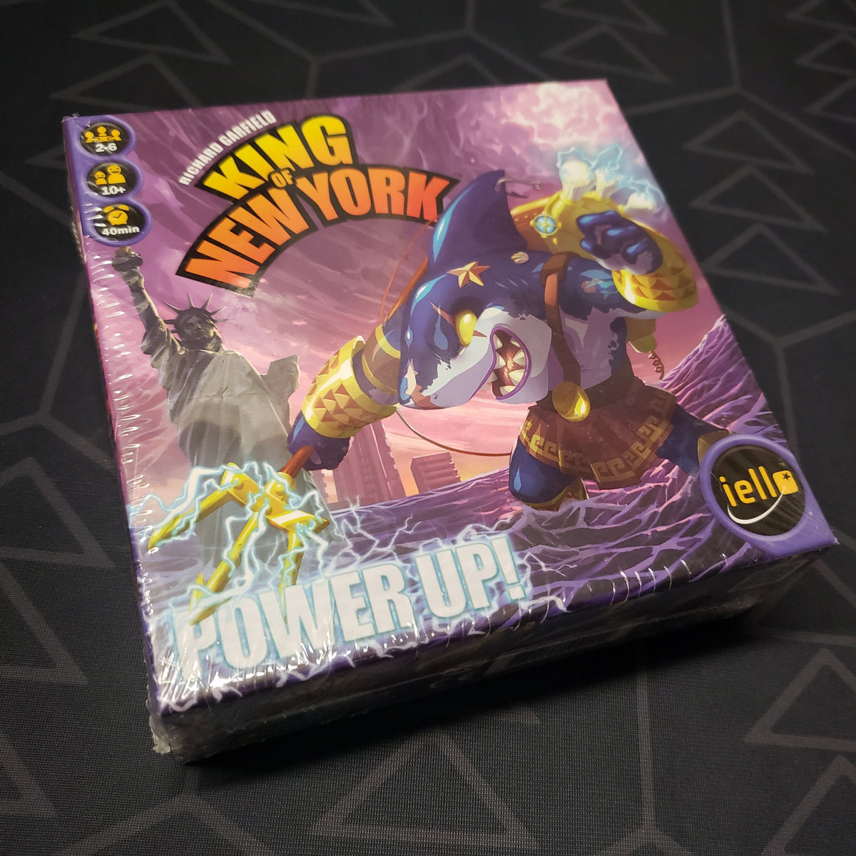 Image shows the front cover of the box of the Power Up! expansion for the board game King of New York